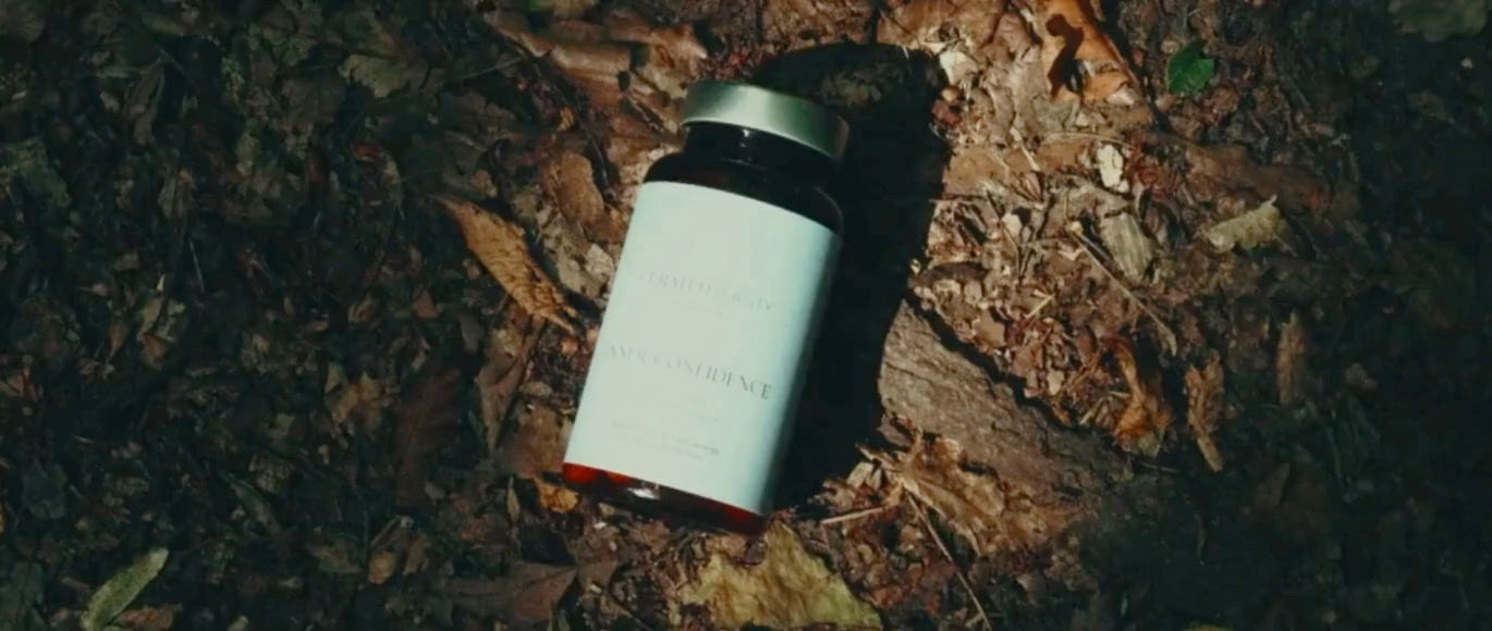 Woman takes Curated Beauty supplement in a sunny forest