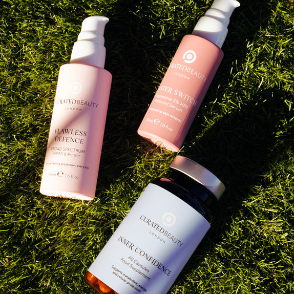 Curated Beauty products laying in grass