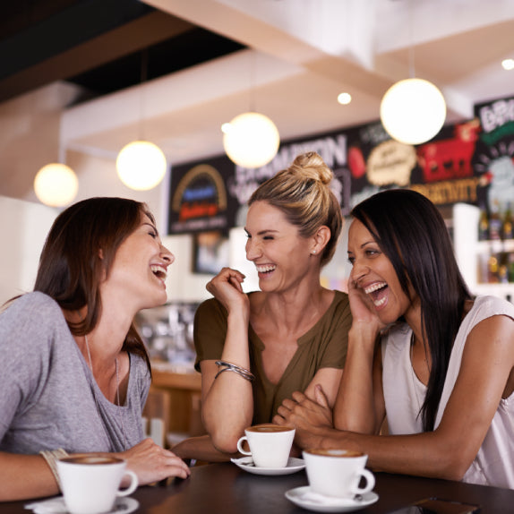 Three women laughing together