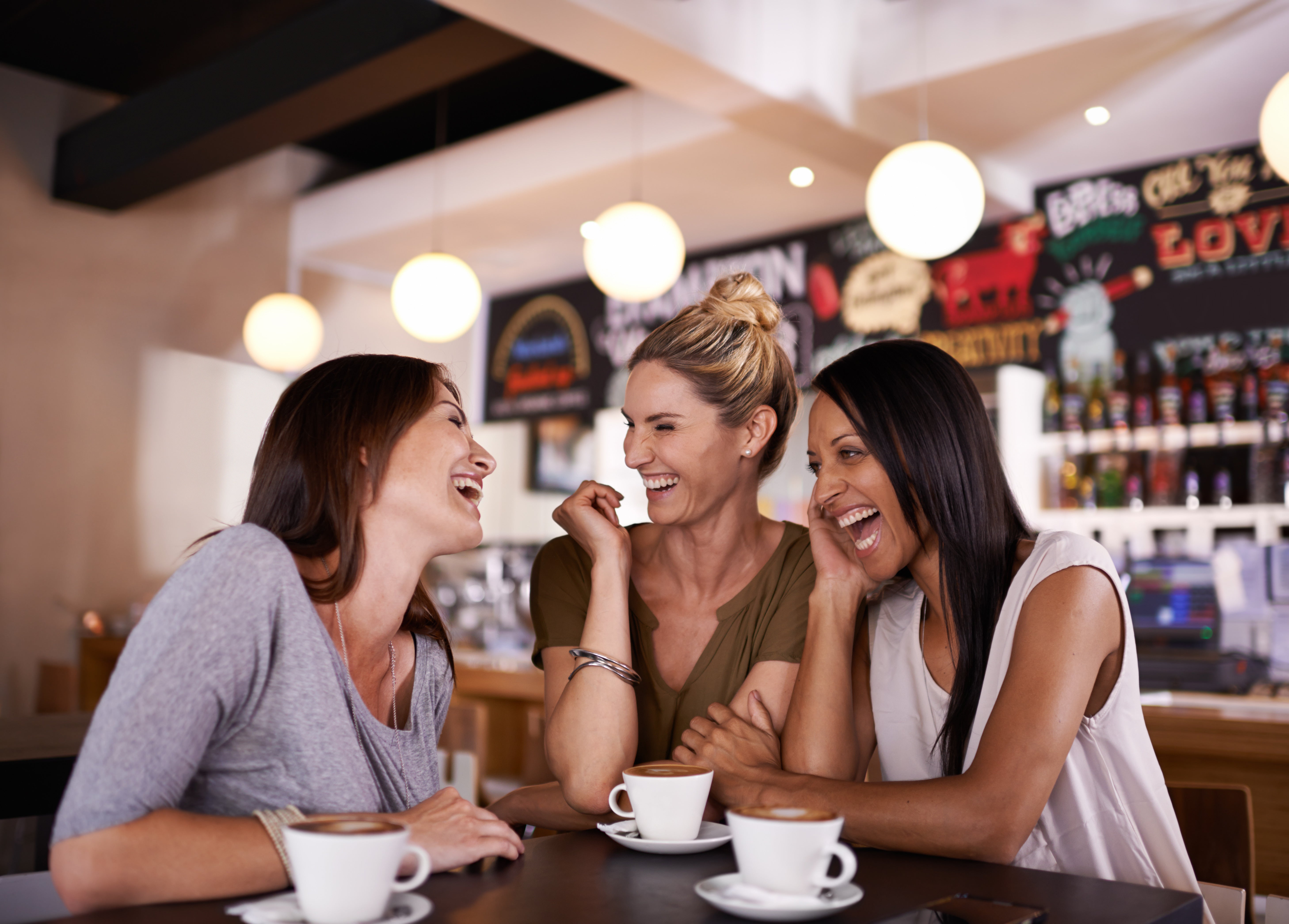 Three women laughing together